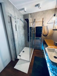 a bathroom with a shower and a sink at Bovis APARTMENT - Gdynia Center Rezydencja Redłowo in Gdynia