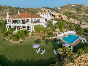 an aerial view of a large house with a swimming pool at Villa de lujo en Playa de Fornells in Fornells