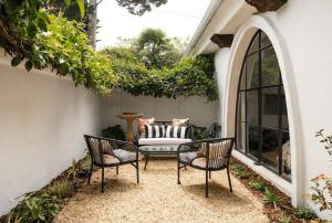 a patio with two chairs and a couch at Cozy New - Casa Blanca Suite B1 in Montecito