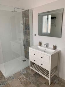 a white bathroom with a sink and a shower at Villa le Yucca proche des plages catalanes in Bompas