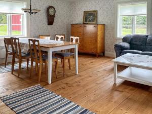 a living room with a table and chairs at Holiday home ULRICEHAMN VII in Ulricehamn