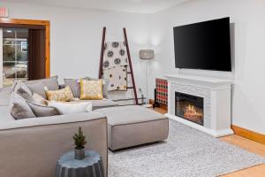 a living room with a couch and a fireplace at Wolfjaw Lodge in Wilmington