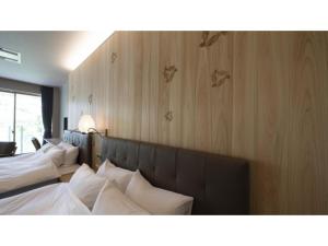 a row of beds with white pillows in a room at Hotel Sekisuien - Vacation STAY 44700v in Gujo