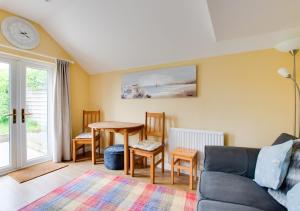 a living room with a couch and a table at Scapa Lodge in Tunstall