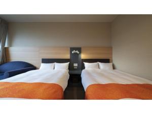 a room with two beds and a blue chair at Hotel Sekisuien - Vacation STAY 44651v in Gujo