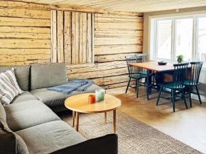 a living room with a couch and a table at Holiday home ÅSTOL 