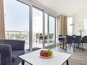 a living room with a table with a bowl of fruit at Apartment with Panoramic Marina Views in Wendtorf