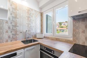 a kitchen with a sink and a window at Apartment Silvana in Split
