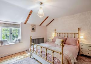 a bedroom with a bed and a window at Rose Cottage - Sedgeford in Sedgeford