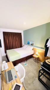 a hotel room with a bed and a desk with a laptop at URB Hotel in Fortaleza +20 photos