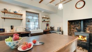 a kitchen with a table with a bowl of fruit on it at Woodside 