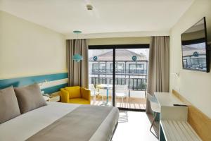 a hotel room with a bed and a desk at Vanilla Garden Boutique Hotel - Adults Only in Playa de las Americas