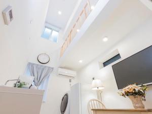 a room with white walls and a staircase with a tv at towanosumika -1 - Vacation STAY 45957v in Tokyo