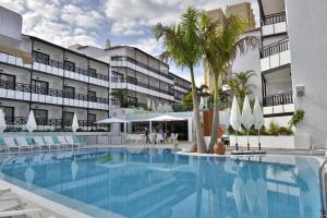 a large swimming pool in front of a hotel at Vanilla Garden Boutique Hotel - Adults Only in Playa de las Americas
