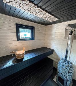 a sauna with a wooden bench in a room at Kaasiku-Liiva Talu in Jõgela