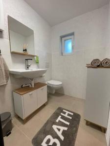 Apartment Mirabelle 3 في Püttlingen: حمام مع حوض ومرحاض ومرآة