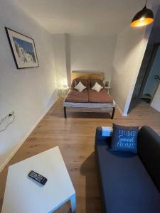 Apartment Mirabelle 3 في Püttlingen: غرفة معيشة مع سرير وأريكة