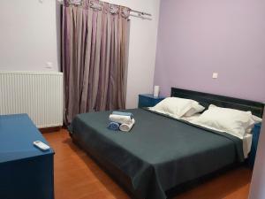 a bedroom with a bed with two towels on it at MARMARI Village in Ayía Marína