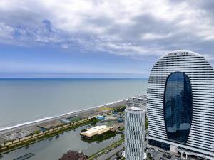 a view of a large building next to the ocean at ORBI CITY in BATUMI in Batumi