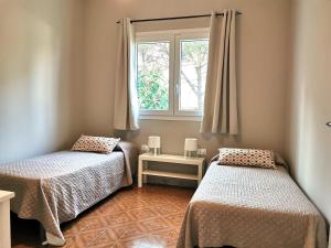 a room with two beds and a window at Villa Mar in Noto Marina +14 photos