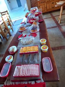 a long table with plates and utensils on it at Pousada DuBaldo in Holambra
