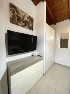 a living room with a flat screen tv on a wall at la casetta di Sophia in Torrenova