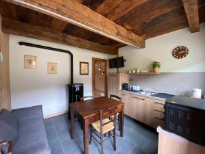 a kitchen and dining room with a wooden table at L'Oasi di Sodani1 in Sampeyre