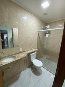 a bathroom with a toilet and a sink and a shower at Casa em Santa Teresa-ES in Santa Teresa