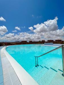 a large swimming pool on top of a building at Villa Aloe in Lajares