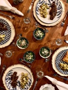 a wooden table with plates of food on it at Campito Loving in Higuey