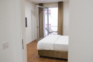 a bedroom with a bed and a balcony at Aroma Apartment, Maschio Angioino-Porto Di Napoli in Naples