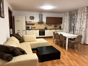 a living room with a couch and a table and a kitchen at House with pool and sea view in Bar