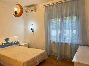 a bedroom with a bed and a large window at House with pool and sea view in Bar +21 photos