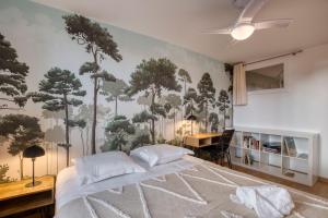 - une chambre avec un grand lit recouvert d'arbres dans l'établissement Le Carnot - MyCosyApart, Duplex Cœur de Ville et Lac, climatisé, à Annecy