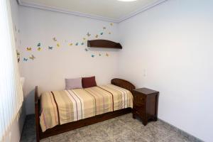 a bedroom with a bed with butterflies on the wall at Lo Raconet de Júlia in Vinaròs