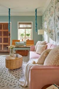 a living room with a pink couch and a table at The Villas at Spanish Court in Minden