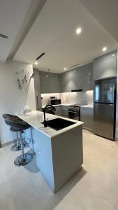 a large kitchen with a counter and a refrigerator at Luxury 2 bedrooms 5 minutes from Burj Khalifa in Dubai