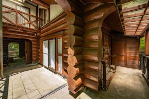 an indoor hallway of a log home with wooden walls at ログハウスGrazzi in Nasu-yumoto