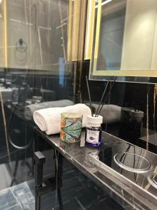 a bathroom with a counter with towels and a mirror at Luxury 2 bedrooms 5 minutes from Burj Khalifa in Dubai
