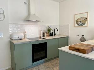 a kitchen with a sink and a stove top oven at Stück vom Glück in Enkirch