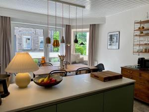 a kitchen with a table with a bowl of fruit on it at Stück vom Glück in Enkirch