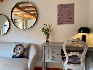 a bedroom with a desk and a chair and a mirror at Stück vom Glück in Enkirch