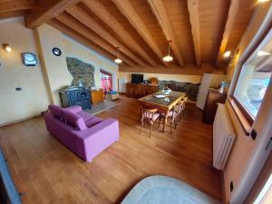 salon z fioletową kanapą i stołem w obiekcie Chalet la terrazza vista lago w mieście Bellano