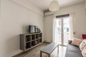 a living room with a couch and a table at Mariners Friend in Piraeus