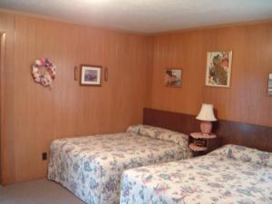 a hotel room with two beds and a lamp at Patras Grand Beach Motel in Old Orchard Beach