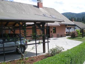 a house with a car parked in front of it at Apartments Janjusevic in Bled