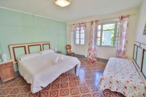 Postel nebo postele na pokoji v ubytování HONEY HOME Ponzone