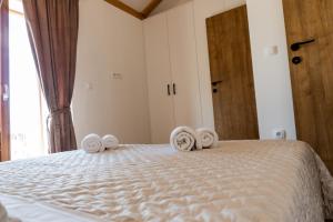 ein Schlafzimmer mit einem Bett mit Handtüchern darauf in der Unterkunft Holiday Home Rakova in Gornje Selo
