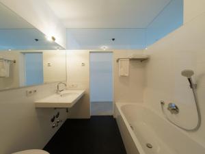 a bathroom with a sink and a tub and a toilet at KAJO269 FERIENcc WOHNUNGEN IN DER ALTSTADT in Freiburg im Breisgau +97 photos