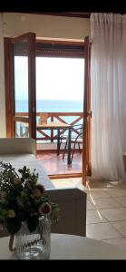 a living room with a vase of flowers on a table at Seafront Family Apartment Ellie in Skala Fourkas